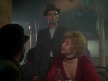 Movie still from “Moulin Rouge” (1952), directed by John Huston – A man and a woman are sitting at a table; Medium shot, Over the shoulder angle