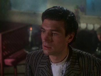 Movie still from “Moulin Rouge” (1952), directed by John Huston – A person wearing a suit and tie; Close Up shot, Low angle