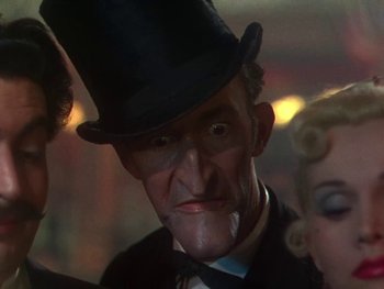 Movie still from “Moulin Rouge” (1952), directed by John Huston – A person wearing a top hat; Close Up shot, Low angle
