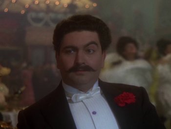 Movie still from “Moulin Rouge” (1952), directed by John Huston – A man in a tuxedo with a red flower in his lapel; Close Up shot, Low angle
