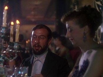 Movie still from “Moulin Rouge” (1952), directed by John Huston – A man and a woman sitting at a dinner table; Close Up shot, Over the shoulder angle