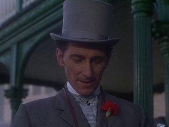 Movie still from “Moulin Rouge” (1952), directed by John Huston – A person wearing a top hat; Close Up shot, Over the shoulder angle