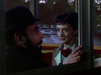 Movie still from “Moulin Rouge” (1952), directed by John Huston – A man and a woman looking at each other through a window; Close Up shot, Over the shoulder angle