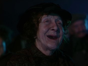 Movie still from “Moulin Rouge” (1952), directed by John Huston – An older woman with a hat and a smile; Close Up shot, Low angle
