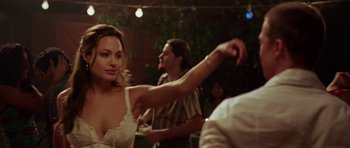 Movie still from “Mr. & Mrs. Smith” (2005), directed by Doug Liman – A man and a woman are dancing in front of other people; Medium shot, Over the shoulder angle