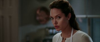 Movie still from “Mr. & Mrs. Smith” (2005), directed by Doug Liman – A woman in a white shirt is looking to her left; Close Up shot, Over the shoulder angle