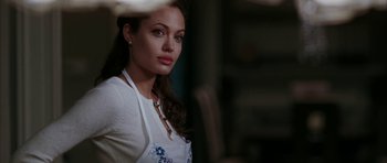 Movie still from “Mr. & Mrs. Smith” (2005), directed by Doug Liman – A beautiful woman with long dark brown hair; Close Up shot, Over the shoulder angle