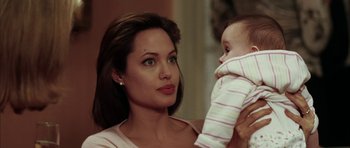 Movie still from “Mr. & Mrs. Smith” (2005), directed by Doug Liman – A woman holding a baby in her arms; Close Up shot, Over the shoulder angle