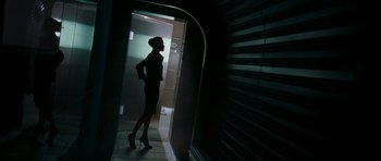 Movie still from “Mr. & Mrs. Smith” (2005), directed by Doug Liman – A woman standing in a doorway with her hands on her hips; Wide shot, Low angle