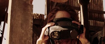 Movie still from “Mr. & Mrs. Smith” (2005), directed by Doug Liman – A woman is holding a video camera up to her face; Close Up shot, Over the shoulder angle