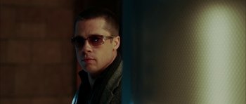 Movie still from “Mr. & Mrs. Smith” (2005), directed by Doug Liman – A person wearing a jacket and sunglasses; Close Up shot, Low angle