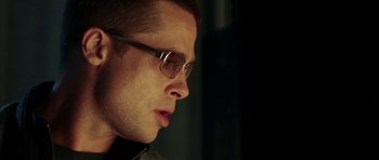 Movie still from “Mr. & Mrs. Smith” (2005), directed by Doug Liman – A person wearing glasses; Close Up shot, Low angle