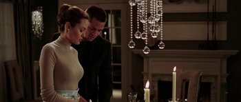 Movie still from “Mr. & Mrs. Smith” (2005), directed by Doug Liman – A man and a woman standing in front of a fireplace; Medium shot, Low angle