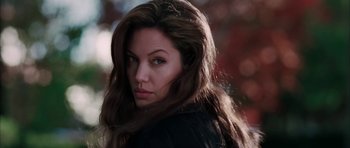 Movie still from “Mr. & Mrs. Smith” (2005), directed by Doug Liman – A person with long brown hair; Close Up shot, Over the shoulder angle