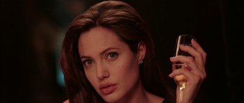 Movie still from “Mr. & Mrs. Smith” (2005), directed by Doug Liman – A person wearing a black shirt; Close Up shot, Over the shoulder angle