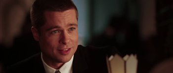 Movie still from “Mr. & Mrs. Smith” (2005), directed by Doug Liman – A person wearing a suit and tie; Close Up shot, Over the shoulder angle