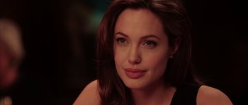 Movie still from “Mr. & Mrs. Smith” (2005), directed by Doug Liman – A person with long brown hair; Close Up shot, Over the shoulder angle