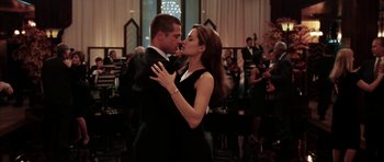 Movie still from “Mr. & Mrs. Smith” (2005), directed by Doug Liman – A man and a woman dancing in front of an orchestra; Medium shot, Low angle