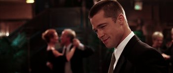 Movie still from “Mr. & Mrs. Smith” (2005), directed by Doug Liman – A man standing next to another man in a suit; Close Up shot, Over the shoulder angle