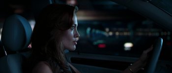 Movie still from “Mr. & Mrs. Smith” (2005), directed by Doug Liman – A beautiful young woman sitting in a car; Close Up shot, Over the shoulder angle
