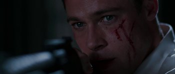 Movie still from “Mr. & Mrs. Smith” (2005), directed by Doug Liman – A person with blood on his face; Extreme Close Up shot, Over the shoulder angle