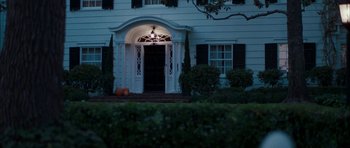 Movie still from “Mr. & Mrs. Smith” (2005), directed by Doug Liman – A front door of a house lit up at night; Wide shot, High angle