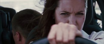 Movie still from “Mr. & Mrs. Smith” (2005), directed by Doug Liman – A woman's face as she drives a car; Close Up shot, Low angle