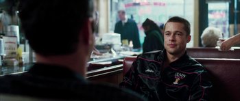 Movie still from “Mr. & Mrs. Smith” (2005), directed by Doug Liman – A man sitting at a table in front of another man; Close Up shot, Over the shoulder angle