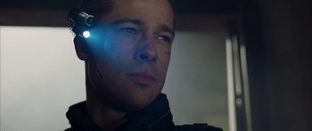 Movie still from “Mr. & Mrs. Smith” (2005), directed by Doug Liman – A person with a light in his ear; Close Up shot, Over the shoulder angle