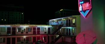Movie still from “Mr. & Mrs. Smith” (2005), directed by Doug Liman – A building that is lit up at night time; Extreme Wide shot, Low angle