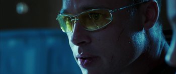 Movie still from “Mr. & Mrs. Smith” (2005), directed by Doug Liman – A person wearing a pair of yellow glasses; Close Up shot, Low angle