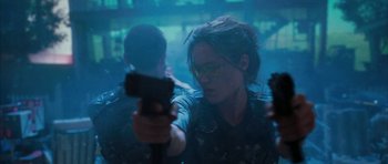 Movie still from “Mr. & Mrs. Smith” (2005), directed by Doug Liman – A man and a woman holding guns in a room; Medium shot, Over the shoulder angle