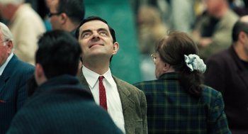 Movie still from “Mr. Bean's Holiday” (2007), directed by Steve Bendelack – A man wearing a suit and tie looking up; Close Up shot, Low angle