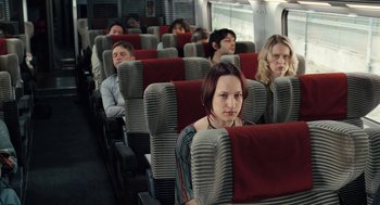 Movie still from “Mr. Bean's Holiday” (2007), directed by Steve Bendelack – A group of people sitting on a train car; Wide shot, High angle