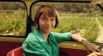 Movie still from “Mr. Bean's Holiday” (2007), directed by Steve Bendelack – A woman sitting in the driver's seat of a vehicle; Close Up shot, Over the shoulder angle
