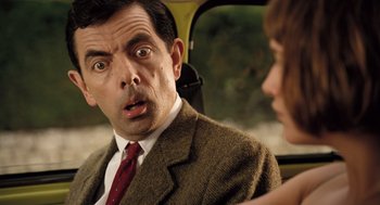 Movie still from “Mr. Bean's Holiday” (2007), directed by Steve Bendelack – A man and a woman in a car looking at each other; Close Up shot, Low angle