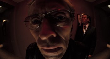 Movie still from “Mr. Bean's Holiday” (2007), directed by Steve Bendelack – A person wearing glasses and a hat; Extreme Close Up shot, Low angle