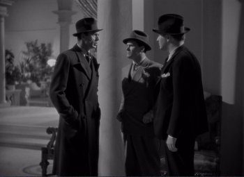 Movie still from “Mr. Deeds Goes to Town” (1936), directed by Frank Capra – A group of men standing next to each other wearing hats; Medium shot, High angle