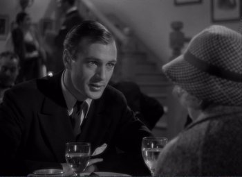 Movie still from “Mr. Deeds Goes to Town” (1936), directed by Frank Capra – A black and white photo of a man and a woman at a table; Close Up shot, Over the shoulder angle