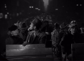 Movie still from “Mr. Deeds Goes to Town” (1936), directed by Frank Capra – A black and white photo of a group of men in hats; Medium shot, High angle