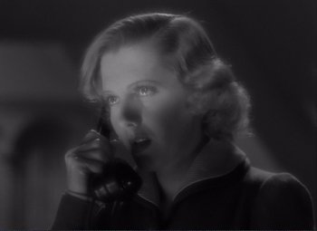 Movie still from “Mr. Deeds Goes to Town” (1936), directed by Frank Capra – A woman talking on a phone in a black and white photo; Close Up shot, Low angle