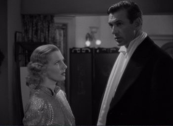 Movie still from “Mr. Deeds Goes to Town” (1936), directed by Frank Capra – A man and a woman standing next to each other in a room; Medium shot, Low angle