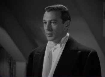 Movie still from “Mr. Deeds Goes to Town” (1936), directed by Frank Capra – A black and white photo of a man in a suit; Close Up shot, Low angle