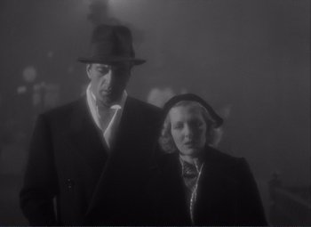 Movie still from “Mr. Deeds Goes to Town” (1936), directed by Frank Capra – A man and a woman standing next to each other; Medium shot, Low angle