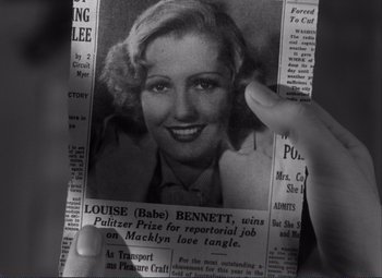 Movie still from “Mr. Deeds Goes to Town” (1936), directed by Frank Capra – A person holding up a picture of a woman; Close Up shot, High angle