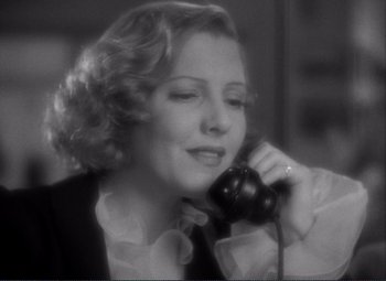 Movie still from “Mr. Deeds Goes to Town” (1936), directed by Frank Capra – A woman talking on a phone while wearing a tie; Close Up shot, High angle