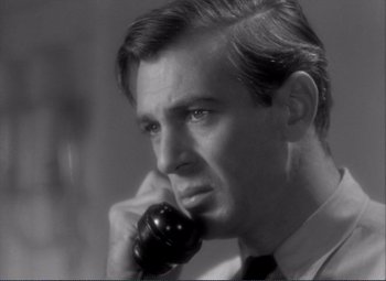 Movie still from “Mr. Deeds Goes to Town” (1936), directed by Frank Capra – A black and white photo of a man talking on a phone; Close Up shot, Low angle