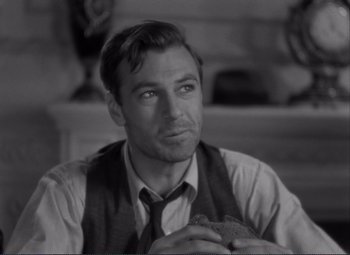 Movie still from “Mr. Deeds Goes to Town” (1936), directed by Frank Capra – Black and white photograph of a man in a tie; Close Up shot, Over the shoulder angle