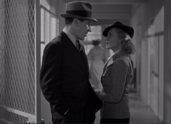 Movie still from “Mr. Deeds Goes to Town” (1936), directed by Frank Capra – A man and a woman standing next to each other; Medium shot, Over the shoulder angle