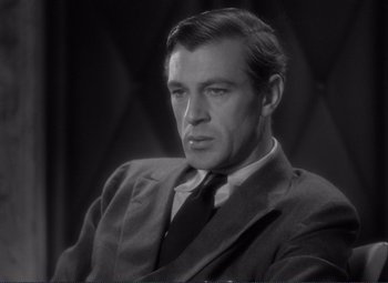 Movie still from “Mr. Deeds Goes to Town” (1936), directed by Frank Capra – A man wearing a suit and tie in a black and white photo; Close Up shot, High angle